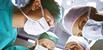 Surgeons round an operating table
