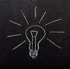A lightbulb drawn on a chalkboard