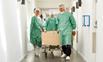 Patient on trolley being wheeled through corridor