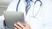 Doctor using electronic tablet device