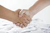 A handshake over a pile of money
