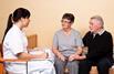 nurse talking to two patients