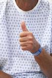 A happy patient thumbs up