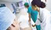 Hospital staff pushing a trolley down corridor