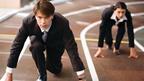 Two people in suits on a running track