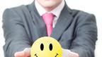 Man holds out smiley face stress ball