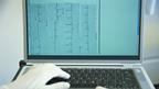 Doctor using laptop to look at lab results