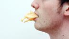 A man with chips in his mouth