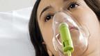 Woman lying in bed with oxygen mask