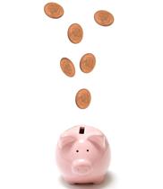 Piggy bank with coins flying into it