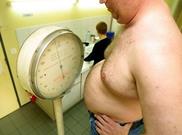 obesity man being weighted on scales