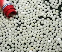 A bottle and a lot of white pills