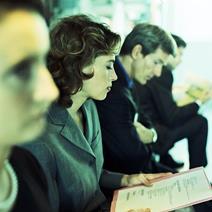 Staff in a group listening to manager