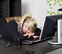 An office worker head down on keyboard