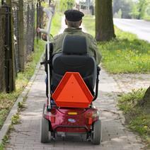 An elderly man on an electric buggy