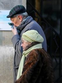 Two elderly people wrapped up against the cold