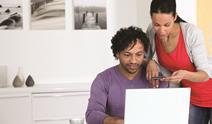 Couple looking at a laptop together