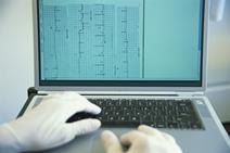 Doctor using laptop to look at lab results