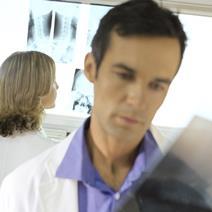 Doctor and nurse looking at clinical X-rays