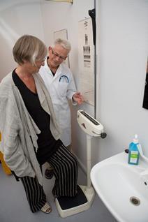 Doctor giving a female patient physical health check