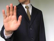 A man making a 'stop' hand signal