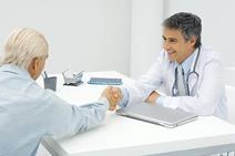 Old man shaking hands with GP