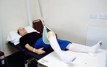 A man on a hospital bed undergoing occupational therapy