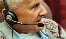 Older man with headset on using skype