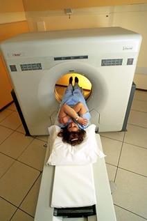 A woman entering an MRI scanner