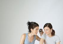 Two girls talking on a mobile phone