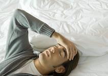 Man with headache in bed