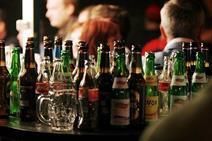 A large amount of bottles on a table in a pub