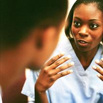 A nurse talking to a patient