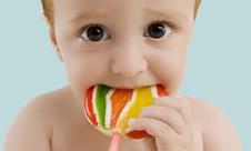 A baby with a big lolly 