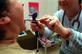 A doctor examining a patient's throat