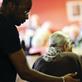 Social care worker helping older lady in wheelchair