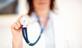 Woman doctor holding stethoscope up in the air