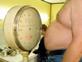 Obese man on scales