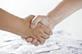 Handshake above a pile of money