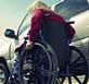 Woman in wheelchair next to her car