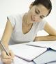 A woman studying and taking notes