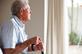 mental health Elderly man with a walking stick looking outside