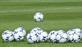Footballs on a grass pitch