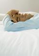 Man lying on bed ill