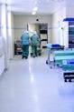 Two nurses walking through hospital ward