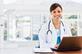 Young doctor with a laptop in bright airy room