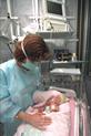 Nurse attending to baby in incubator