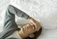 Man with headache in bed