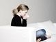Young woman sneezing, ill off work