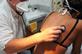 GP checking patient's chest for pneumonia